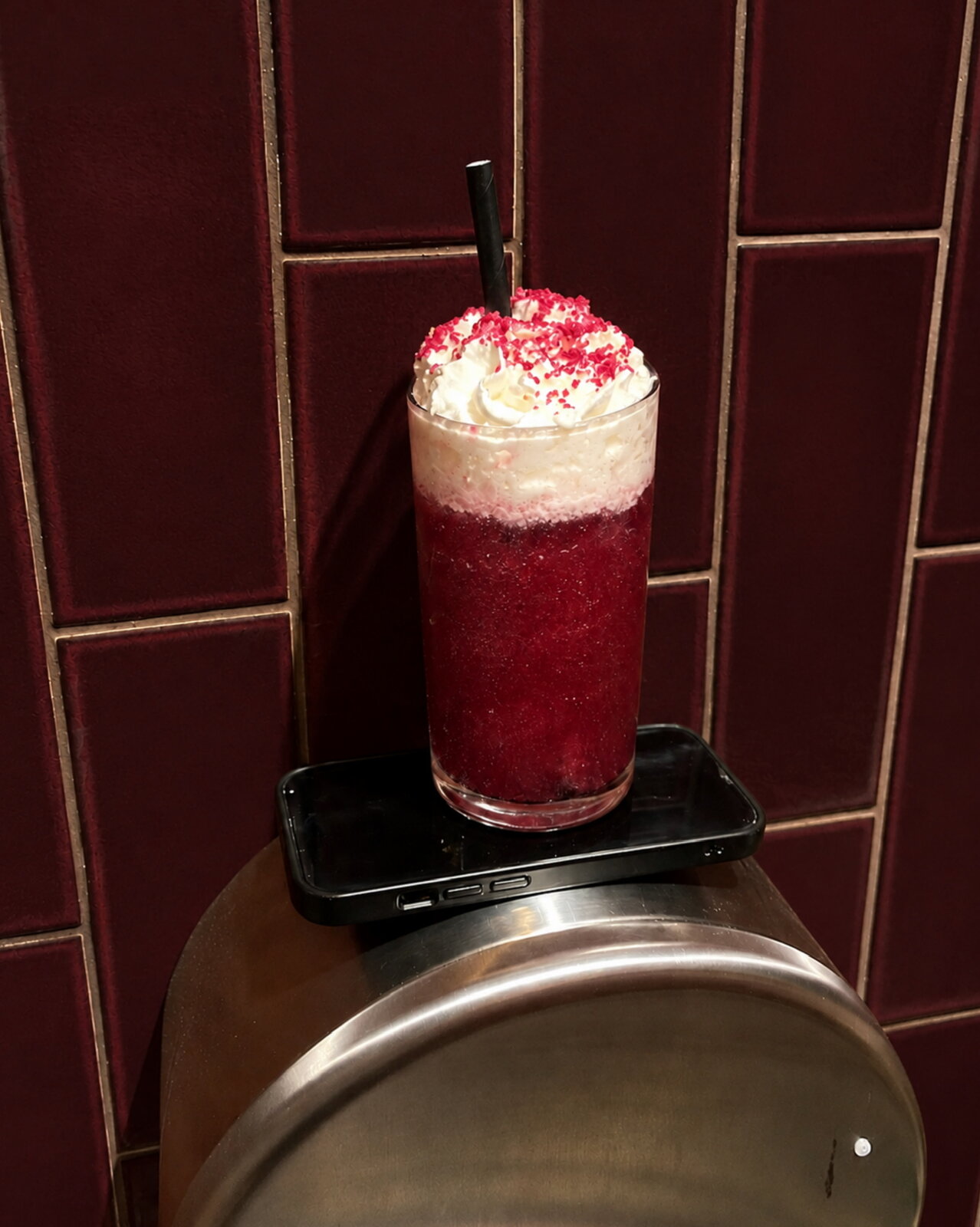 A frozen berry cocktail topped with cream at Nowhere Bar